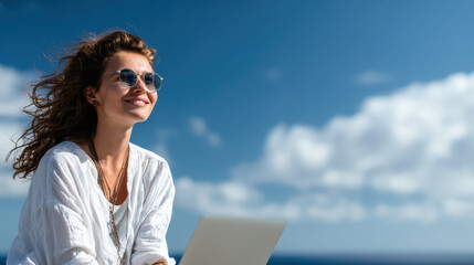 Young Woman Sitting on Rooftop with Laptop Enjoying Sunny Day Amidst Clear Blue Sky and Calm Ocean Breeze