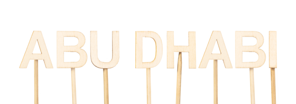 Name of Abu Dhabi, capital of the United Arab Emirates, written in wooden letters on a white background in a neat and elegant layout