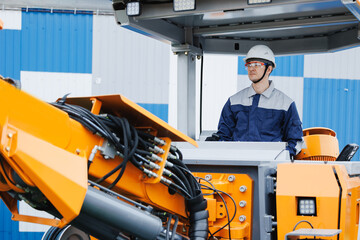 Driver operating heavy machinery for drilling of earth geological work site in safety gear