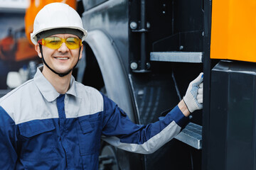 Happy Man driver builder operate crane or excavator at construction site. Industry worker portrait