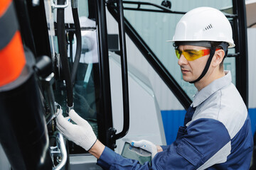 Mechanic with tablet computer control and fix problem of hydraulic hoses from industrial mining...