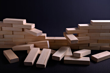 a wall of wooden blocks partially collapsed, creating a new path. Concept of overcoming obstacles