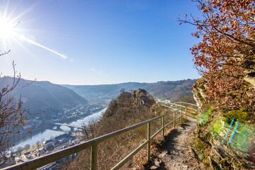 View over the Moselle at sunrise in a winter landscape. The castle and town of Cochem rise on the...