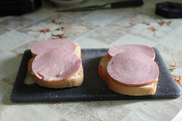 Explore the beauty of two mouthwatering sandwiches served on a stylish black plate. Perfect for food blogs, menus, and culinary designs.