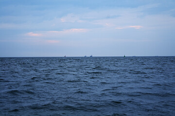 The sea coast of the Baltic Sea with a view to the water plain and several ships on the horizon