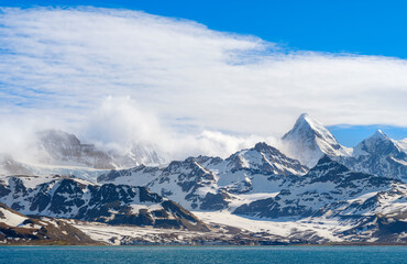 Fototapeta premium Saint Andrews Bay and the huge colonies of king penguins the Allardyce Range in the background. Antarctica, Subantarctic, South Georgia.