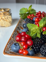 Fresh Berry and Floral Arrangement in Patterned Ceramic Dish