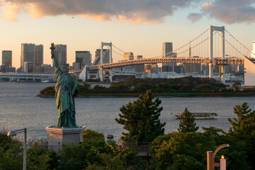 Statue of Liberty on Odaiba Island and Rainbow Bridge Suspension Bridge over North Tokyo Bay on a...