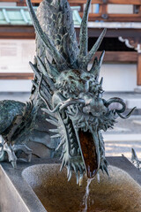 Detail of bronze dragon on Chozuya, Higashi Hongan, Kyoto, Japan