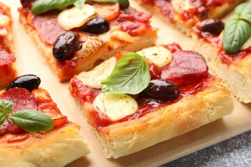 Pieces of tasty homemade pizza on table, closeup