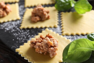 Making ravioli bolognese at wooden table, closeup