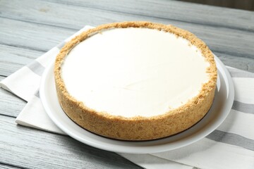 One tasty cheesecake on grey wooden table, closeup