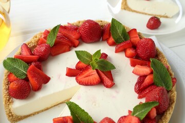 Delicious cheesecake with strawberries and mint on table, above view