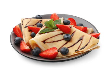 Tasty crepes with berries, chocolate sauce and mint isolated on white