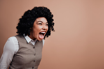 Angry Businesswoman Expressing Emotion Against Beige Background in Stylish Formal Attire