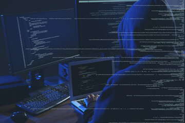 Cyber attack. Hacker working on computers in dark room. Digital code around him