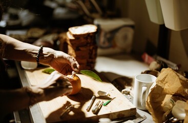 Hands carefully prepare vibrant decorations for cozonac, surrounded by fresh ingredients and...
