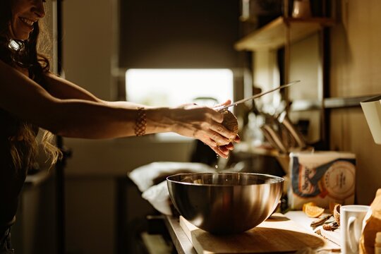 A talented pastry chef skillfully prepares cozonac decorations in a cozy kitchen, showcasing vibrant ingredients and the artistry of food styling. The warm atmosphere invites culinary creativity