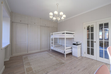 bright room with a white bunk bed, a large wardrobe with sliding doors, and a white chandelier. ...