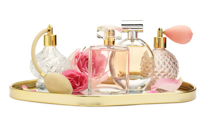 Many different perfume bottles and roses isolated on white