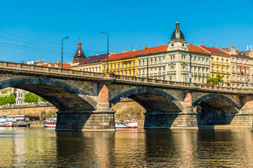 A view from the Vltava river towards the southern side of the Palacke bridge in Prague in springtime