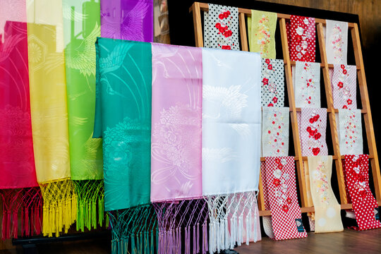 Silk shawls and embroidered kimono collars in store window, Kyoto, Japan