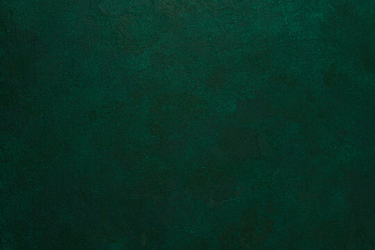 Green textured grunge wall with dark aged plaster and rough surface