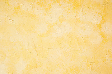 Yellow stucco wall with soft plaster texture and pastel surface