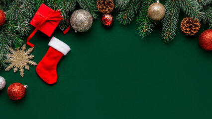 New Year green background with a tree, toys and cones