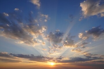 Fototapeta premium Majestic sunset sky with radiant sun rays bursting through fluffy clouds creating a breathtaking natural scene perfect for backgrounds and desktop wallpapers