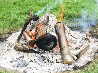 burning firewood in a campfire
