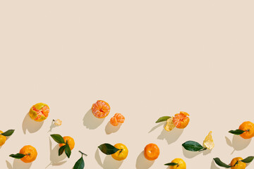Fresh tangerines on beige background with sunlight shadows, minimal aesthetic citrus fruits as...