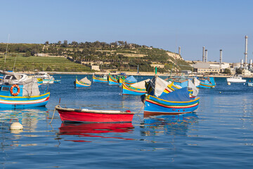Fototapeta premium Malta, Marsaxlokk Harbor. Luzzijiet, plural of luzzu, colorful traditional Maltese fishing boats.