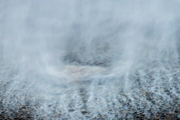 Spain, Playa del Silencio. Shore mist and rocks.