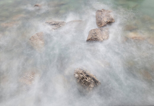 Spain, Playa de Aguilar. Rocks in ocean shore water.