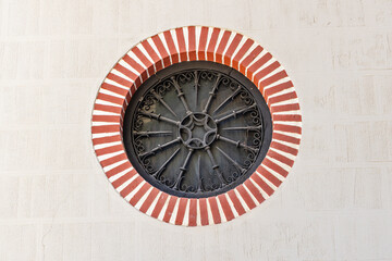 Albaicin, Province of Granada, Andalusia, Spain. A rosette window outlined in red and white stripes.