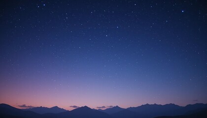 Starry night sky over a majestic silhouette of mountains