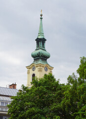 Exterior view of a historical old town building and the beautiful tower of Saint George Martyr...