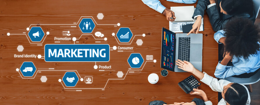 A diverse team of professionals collaborates on a marketing strategy, utilizing digital tools to enhance brand identity and consumer insight in a modern office setting. Amity