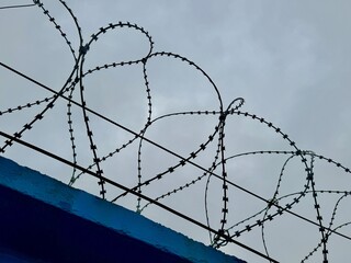 metal wire, fence on the background of the sky. High quality photo
