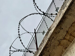 metal wire, fence on the background of the sky. High quality photo