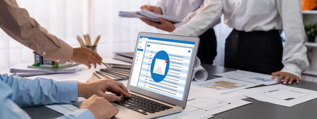 Group of interior architect designer discussing together on blueprint and laptop screen display...
