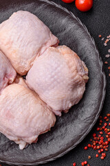 Meat, raw chicken thigh, leg in skin with salt and spices. Raw chicken thigh