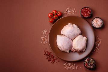 Meat, raw chicken thigh, leg in skin with salt and spices. Raw chicken thigh