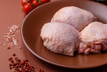 Meat, raw chicken thigh, leg in skin with salt and spices. Raw chicken thigh