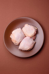 Meat, raw chicken thigh, leg in skin with salt and spices. Raw chicken thigh