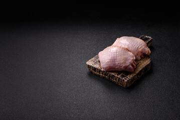 Meat, raw chicken thigh, leg in skin with salt and spices. Raw chicken thigh