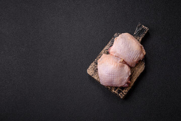 Meat, raw chicken thigh, leg in skin with salt and spices. Raw chicken thigh
