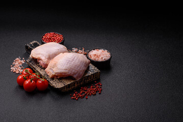 Meat, raw chicken thigh, leg in skin with salt and spices. Raw chicken thigh
