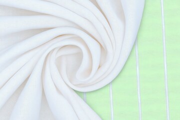 Elegant Ivory Linen Fabric Swirled on Pastel Green Background